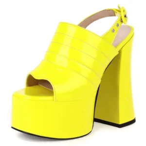 Neon yellow patent gothic platform sandals with open toe and thick flared block heel, front-side view studio shot