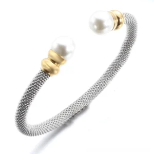 Side profile of antique silver pearl cuff bracelet showing bezel-set pearl detail and gold hardware accents