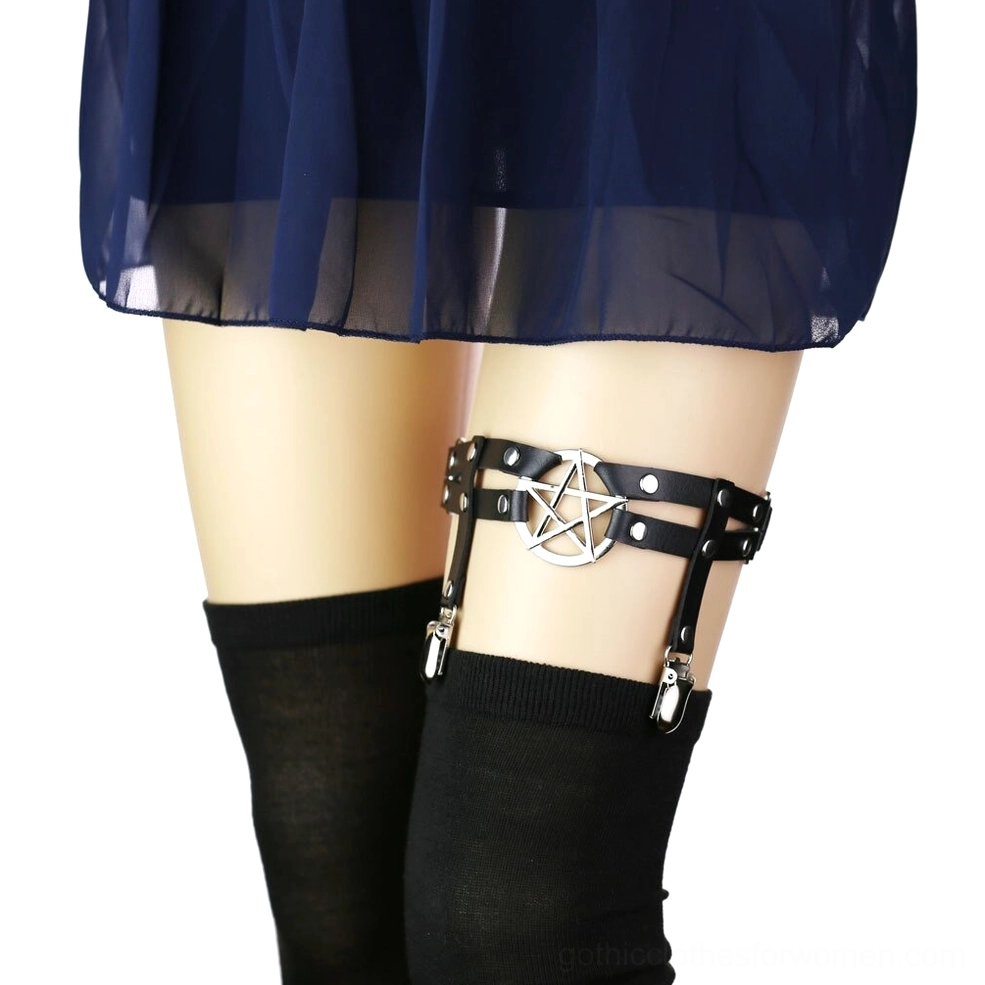 Black pentagram PU leather leg garter belt with silver pentagram pendant worn on female thigh with black thigh-high stockings, side view showcasing metal clip straps and rivets