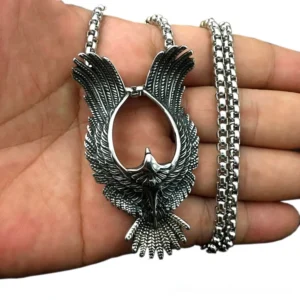 Phoenix pendant held in hand showing scale and beaded chain detail