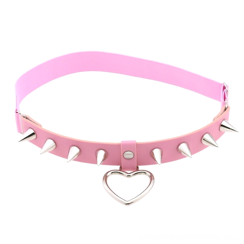 Pink PU leather gothic leg garter with metallic spikes and heart charm pendant, front flat lay