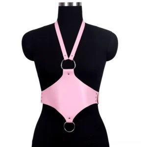 Pink faux leather halter body harness with silver O-ring accents on dress form