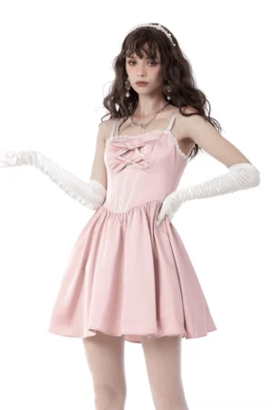 Pink satin gothic bow mini dress front view with white lace trim and double bow accent, modeled with long white elbow gloves