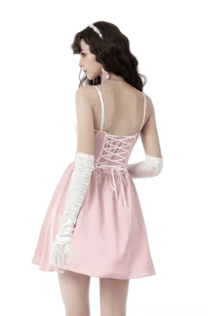 Pink gothic dress rear view showing signature lace-up corset back design with white ribbon lacing and scalloped lace trim