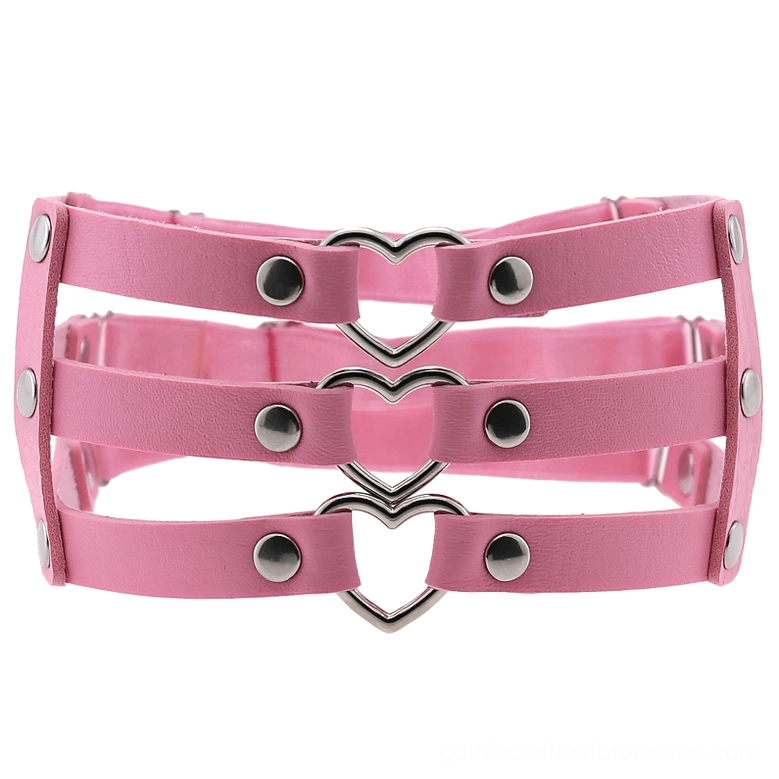 Pink synthetic leather women's leg harness with metal heart and rivets, adjustable straps front view