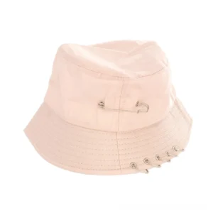 Soft pink gothic bucket sun hat with safety pin and metal ring embellishments, overhead angle product photography