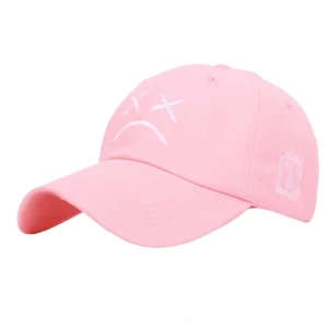 Pink gothic crying face baseball cap, side angle showcase, soft goth aesthetic unisex cap with embroidered sad face motif