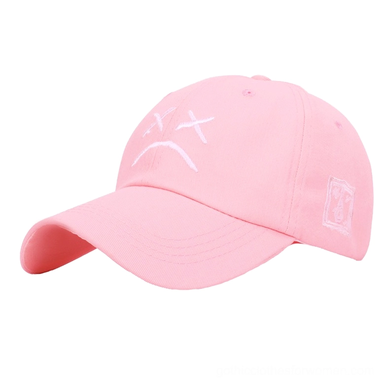 Pink gothic crying face baseball cap, side angle showcase, soft goth aesthetic unisex cap with embroidered sad face motif