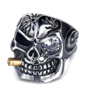 Gothic pirate skull ring with clear crystal eye and bullet - frontal oblique angle displaying carved details