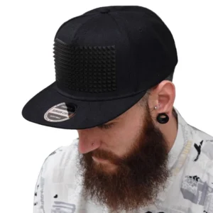 Man wearing black edgy spike baseball cap in close-up, demonstrating unisex fit and pyramid spike design detail