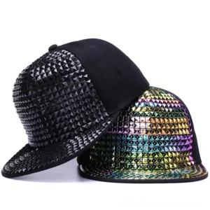 Flat lay view of pyramid stud snapback caps in multiple colors - black, blue, gold, red, silver, and multicolor gothic studs