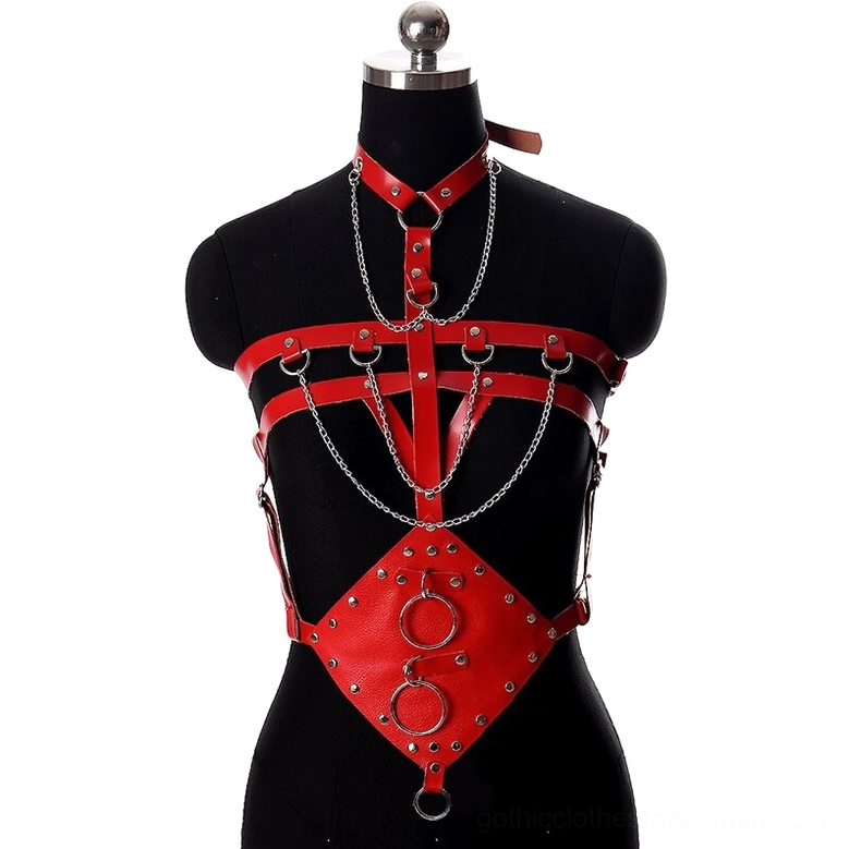 Red PU leather bondage harness belt with silver metal hardware and rivet trim, front view on model, dark gothic women's harness with chains