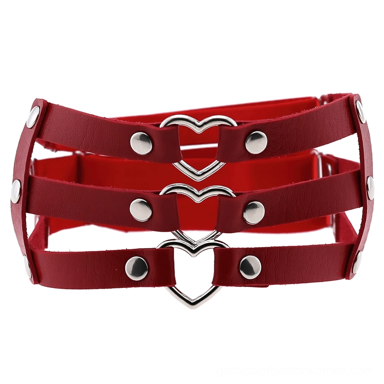 Red burgundy PU leather thigh harness with silver heart embellishment and rivet details flat lay