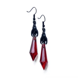 Transparent red gothic bat spike drop earrings with faceted teardrop beads and black metal hooks, flat lay product photography