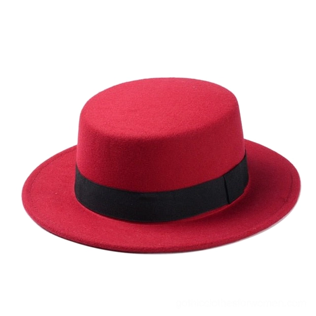 Bright red felt gothic fedora hat with wide flat brim and ribbon band, overhead front angle