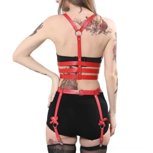 Red leather garter harness back view on tattooed model, featuring Y-shaped back strap design and adjustable silver buckles
