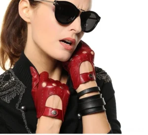 Burgundy red leather gothic gloves featuring cutout perforated details, worn by female model with sunglasses showcasing alternative fashion style