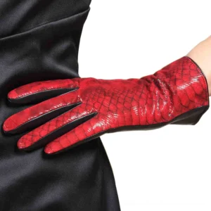 Red gothic leather gloves with web-print pattern worn on arm with black satin dress, close-up side view