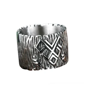 Wide band stainless steel rune talisman ring, front top view highlighting notched edge and embossed rune design