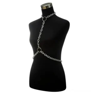 Silver chain body harness one-shoulder gothic design with curb links and O-ring connectors, three-quarter view on black mannequin