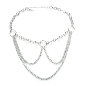 Silver layered chain belt flat lay photography, displaying intricate multi-strand design with central O-ring and tassel details on white background