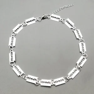 Overhead flat lay of silver gothic choker necklace with adjustable extension chain on grey background