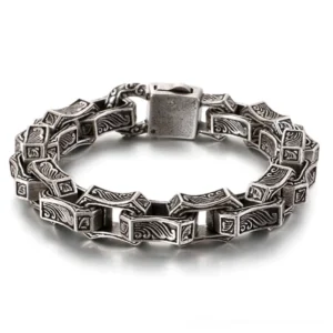 Silver tone gothic engraved chain bracelet with square link design studio flat lay showcase
