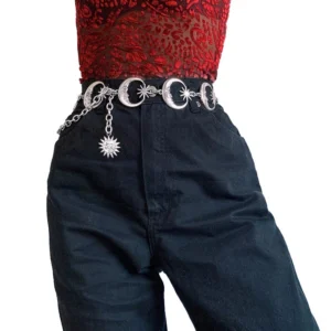 Silver crescent moon and sun charm chain belt worn at high waist on female model, front view with celestial gothic aesthetic