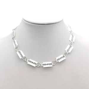 Silver razor blade gothic choker necklace displayed on mannequin bust, front view showing linked blade chain design