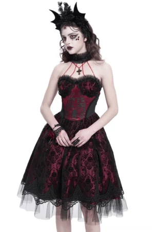 Black burgundy skeleton print gothic corset dress with halter cross strap and lace overlay, worn by model with gothic headpiece in studio setting