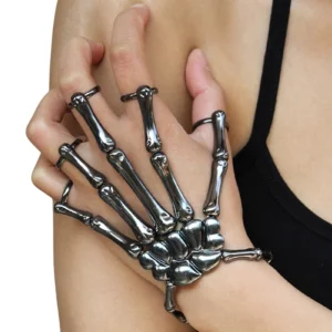 Gunmetal skeleton hand slave bracelet worn on female model showing integrated finger rings and adjustable elastic fit from side angle