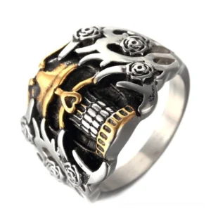 Dual-tone gothic skull ring top oblique view displaying carved rose and flame motifs with hollow skeleton design