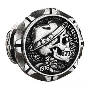 Close-up side view of gothic skull ring featuring notched edge detail, tribal arrow engravings, and vintage silver-tone finish