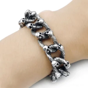 Gothic skull bracelet worn on human wrist showing side profile, vintage silver metal chain with bone toggle clasp
