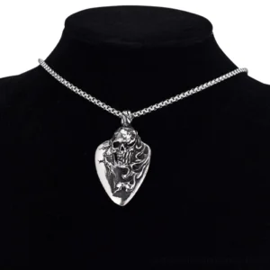 Unisex gothic skull pendant necklace worn on black velvet jewelry stand mannequin, displaying polished silver metal guitar pick design with centered skull motif