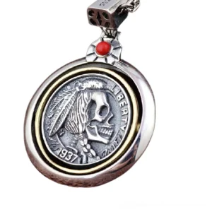 Detailed close-up of engraved vintage coin-inspired skull pendant design with gemstone accent