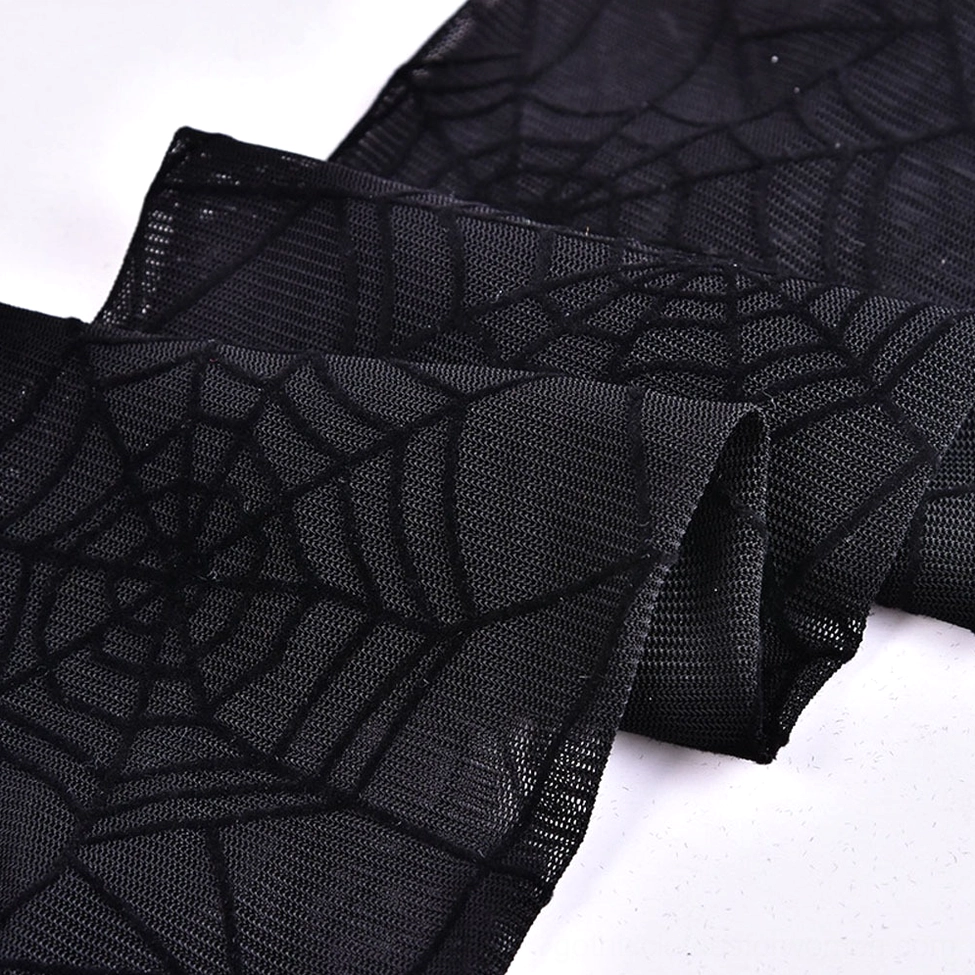 Black mesh fingerless gloves detailed close-up showing intricate spider web texture and sheer nylon material
