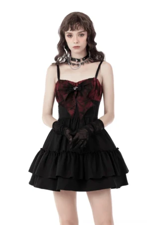 Black and red spiderweb gothic mini dress with detachable bow, front view on model showing puff sleeves and ruffled skirt