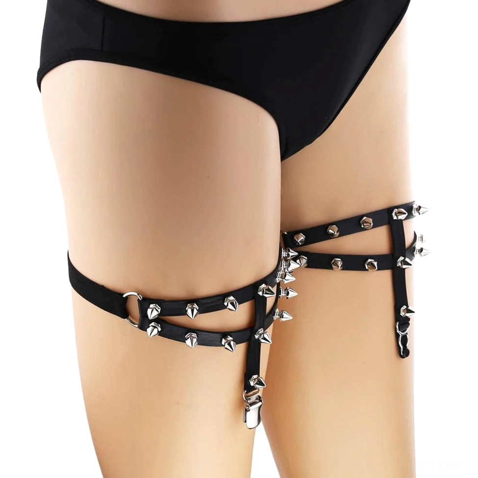 Adjustable spiked leg garter with cross strap design and silver metal studs front detail view