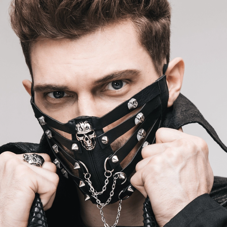 Detailed product view of black steampunk gothic mask showing metal chain embellishments, skull decorations and adjustable leather strap construction