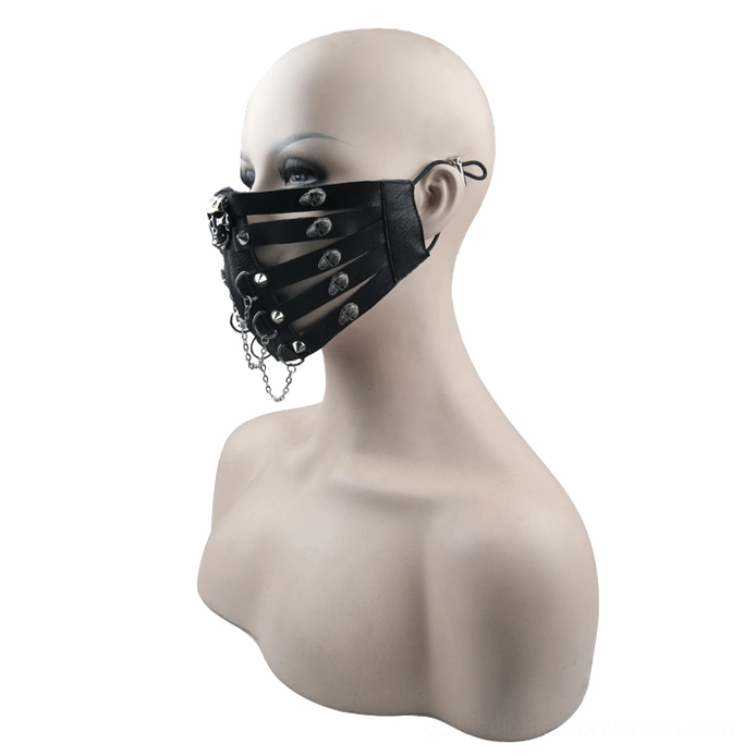 Black steampunk gothic face mask on female mannequin bust, side view showing leather straps, skull studs and hanging metal chain detail