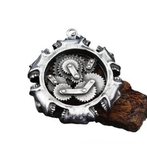 Mechanical steampunk skull pendant with hollow gear design on wooden surface, top-down view showcasing intricate metal details