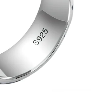 Close-up of sterling silver ring inner band showing S925 authentication stamp and polished finish