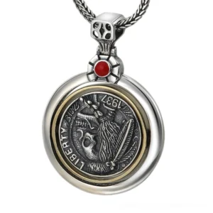 Sterling silver vintage skull pendant front view with double-sided design and red gemstone bail on white background