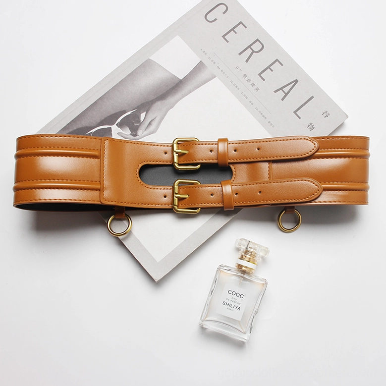 Single tan wide corset belt with dual gold buckles - flat lay product shot