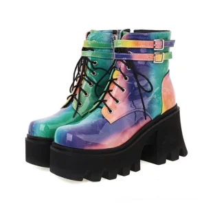 Tie-dye blue purple pink patent leather gothic platform ankle boots with dual buckle straps and lace-up front, front side view on white background