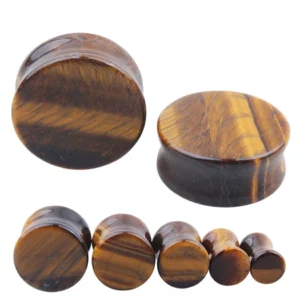 Yellow tigerite stone ear plugs and gauges in multiple sizes displayed front and side view, showing golden striations and polished finish for gothic body jewelry