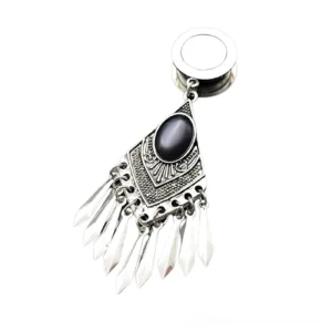 Single tribal gothic tunnel earring - surgical steel with carved tribal motifs and dangling spike tassel pendant, side flat lay view