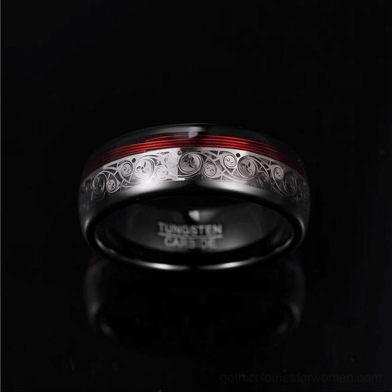 Tungsten steel gothic ring top view showing inner engraving text, silver ethnic patterns, and red trim stripe on black reflective background