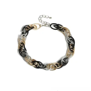 Close-up overhead view of thick twisted oval chain links in mixed metal tones, gothic necklace detail